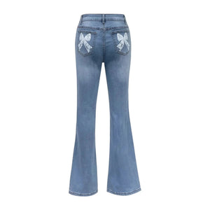 Högmidjade blå flare jeans med rosett-broderi för dam